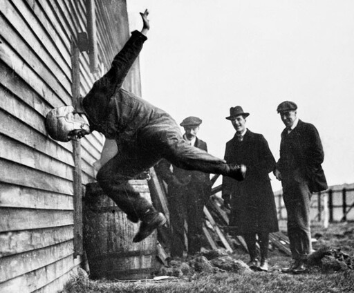 Man hitting head against wall wearing a funky helmet